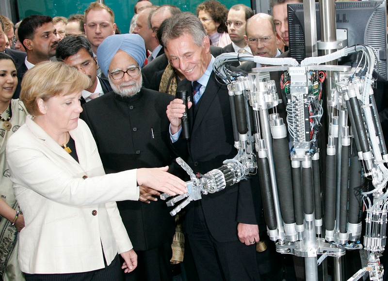 Illustration for article titled Why Is Angela Merkel Always Palling Around With Robots?